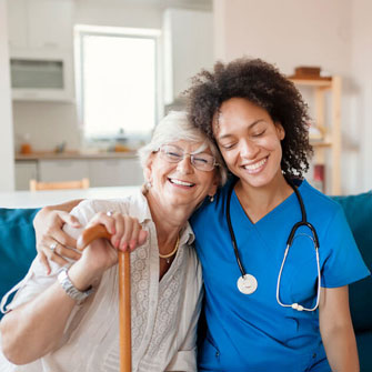 Woman with doctor, smiling.