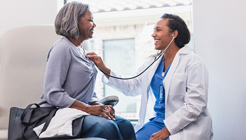 doctor listens to patients heart