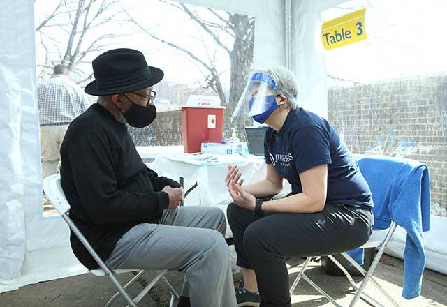 Healthcare provider answering questions from a community member.