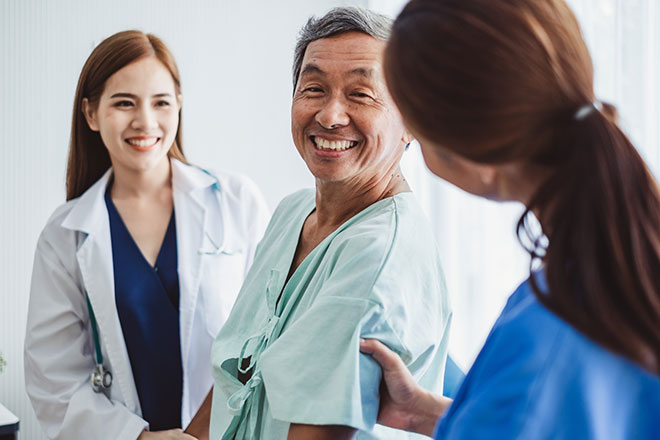 Asian senior facing nurse with doctor.