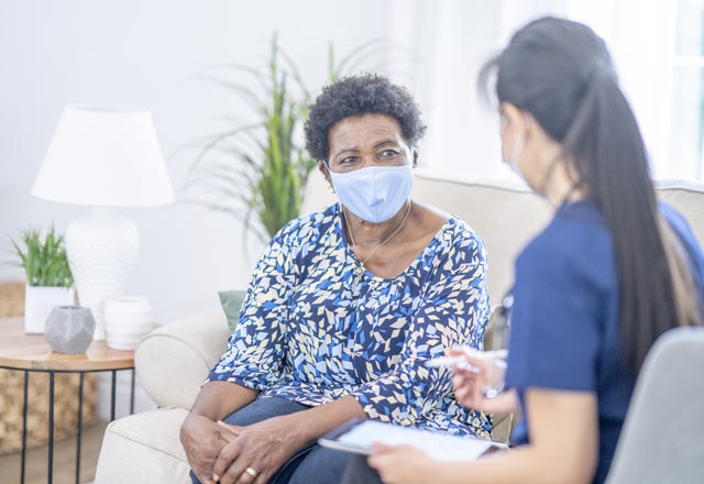 Physician with patient in home