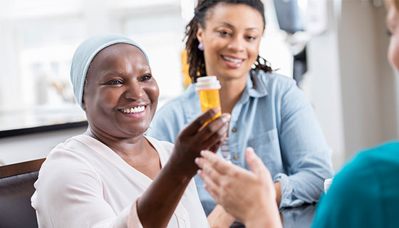 woman getting medicine from a nurse with her daughter