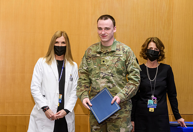 Dr. Miller and Kris Lukish pose with National Guard member Dwyer.