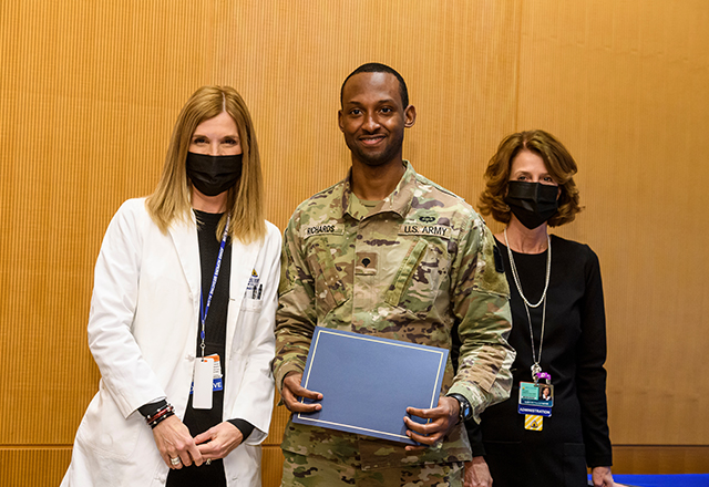 Dr. Miller and Kris Lukish pose with National Guard member Richards.