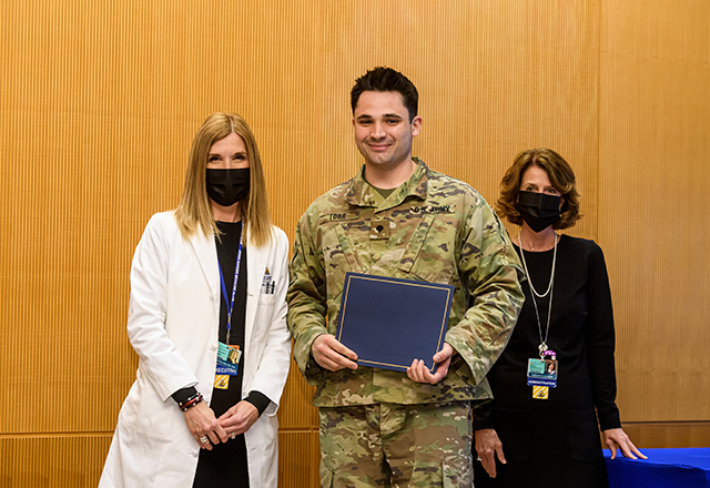 Dr. Miller and Kris Lukish pose with National Guard member Torr.