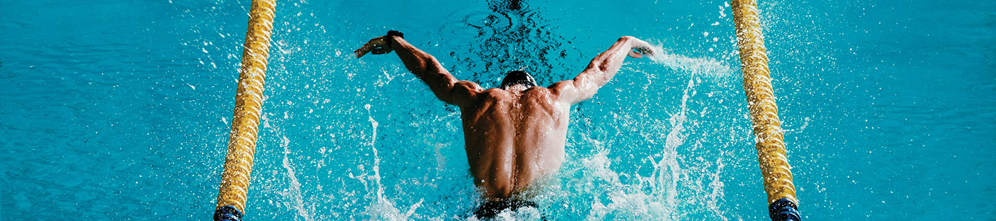 an overhead shot of a man swimming laps in a pool