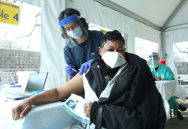 woman receiving a vaccine in a community clinic