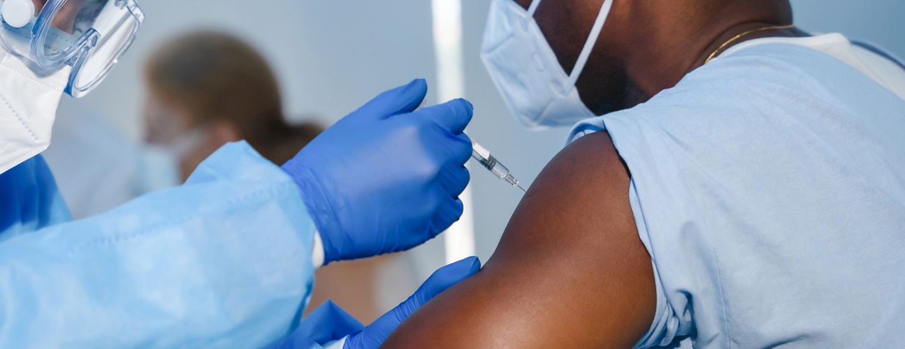 coronavirus vaccine myths covid-19 - doctor administrating vaccine to male patient