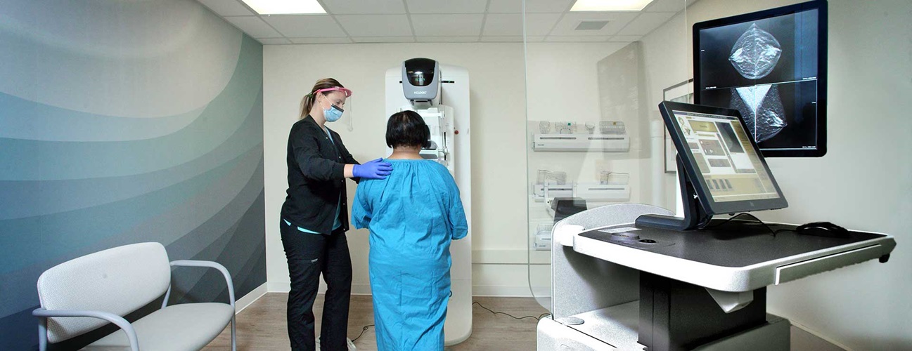 Provider prepares woman for a breast exam