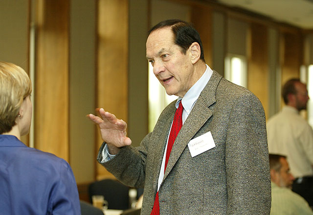 Dr. Daniel Drachman speaking with an attendee at an event.