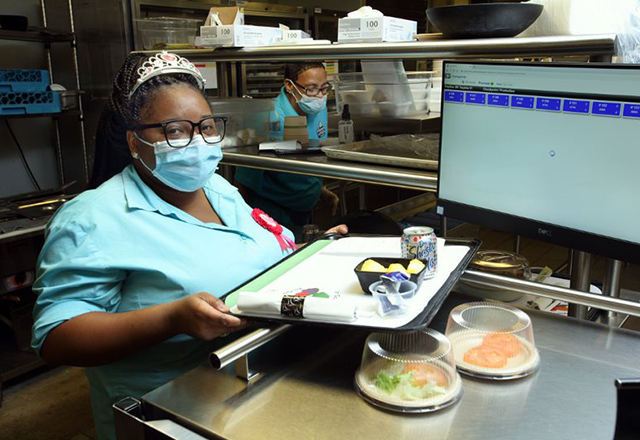 Dawn Silver holding tray of food