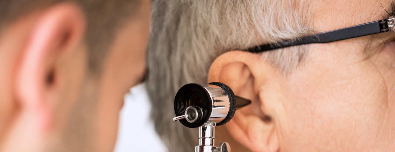 doctor looking in a patient's ear