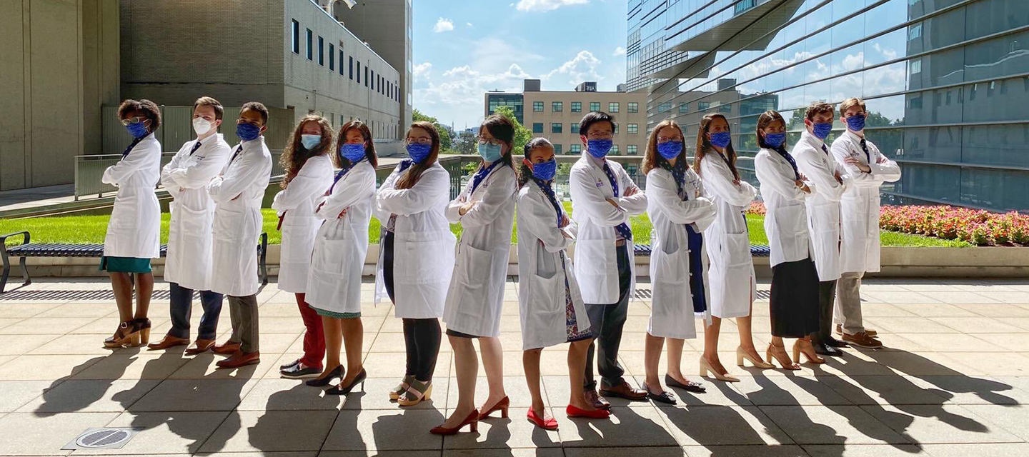 A group of learners stand outside the Miller Research Building.