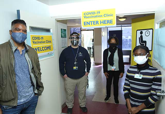 Providers standing at the entryway to the clinic.