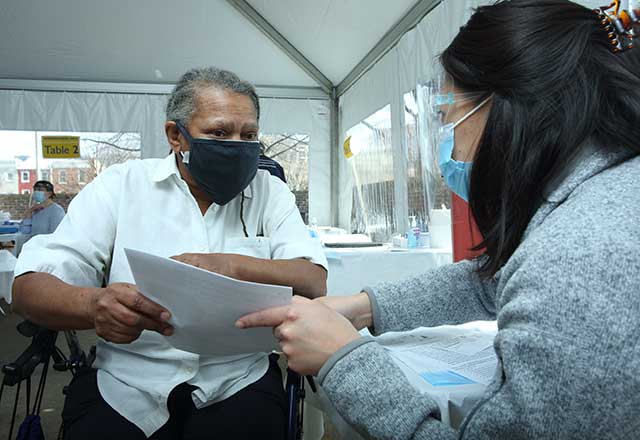 Healthcare provider answering questions in-person.