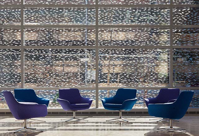 Empty chairs besides large windows with frit in Johns Hopkins Children's Center