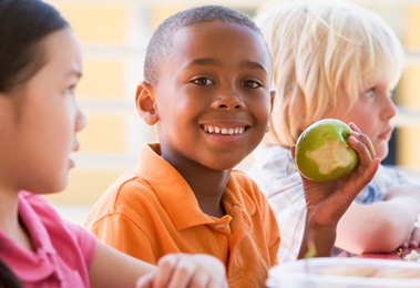 young boy eating an apple