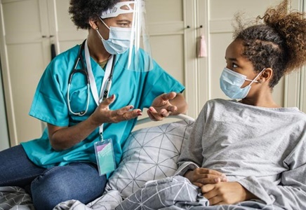 Nurse speaking with teen home care patient