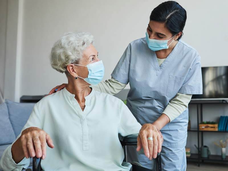 Masked nurse with patient