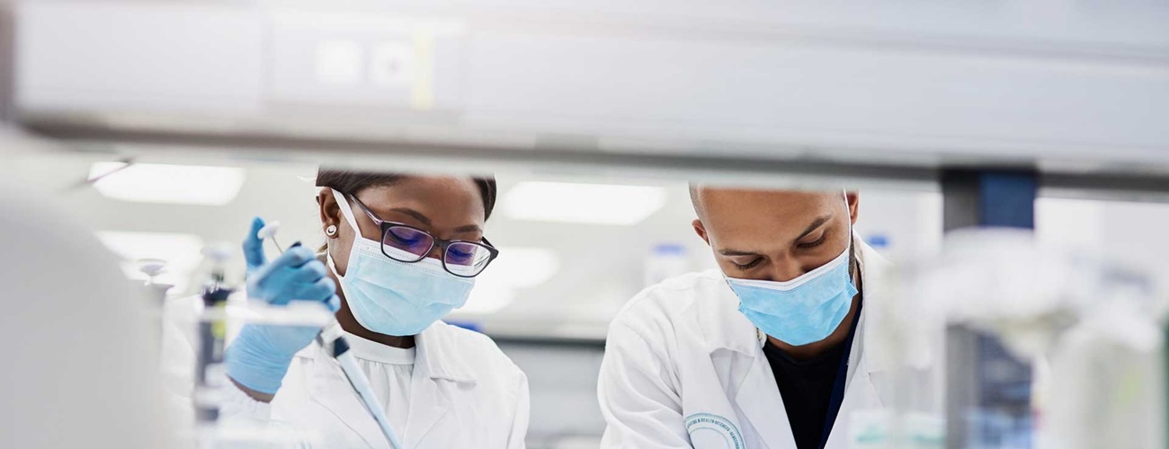 Masked researchers analyzing medical samples