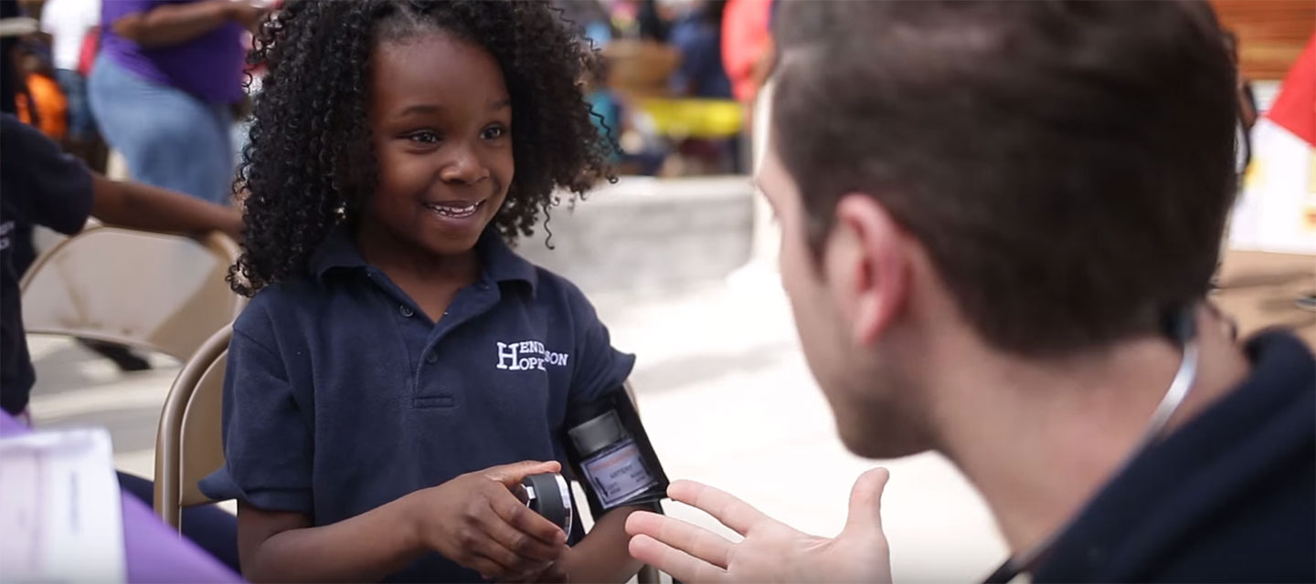 Student checks a doctor's heartbeat.