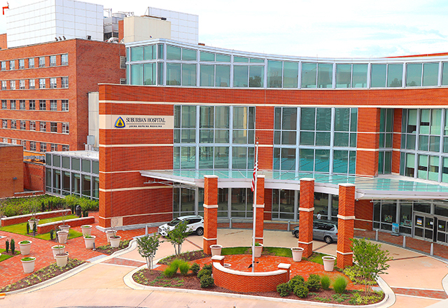 Landscape shot with Suburban parking lot and entrance.