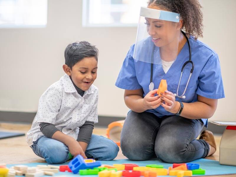 Occupational therapist with a pediatric patient