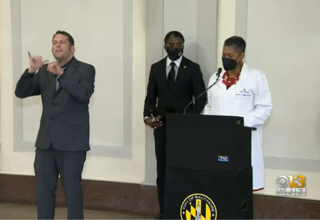 Johns Hopkins employees participating in a press conference