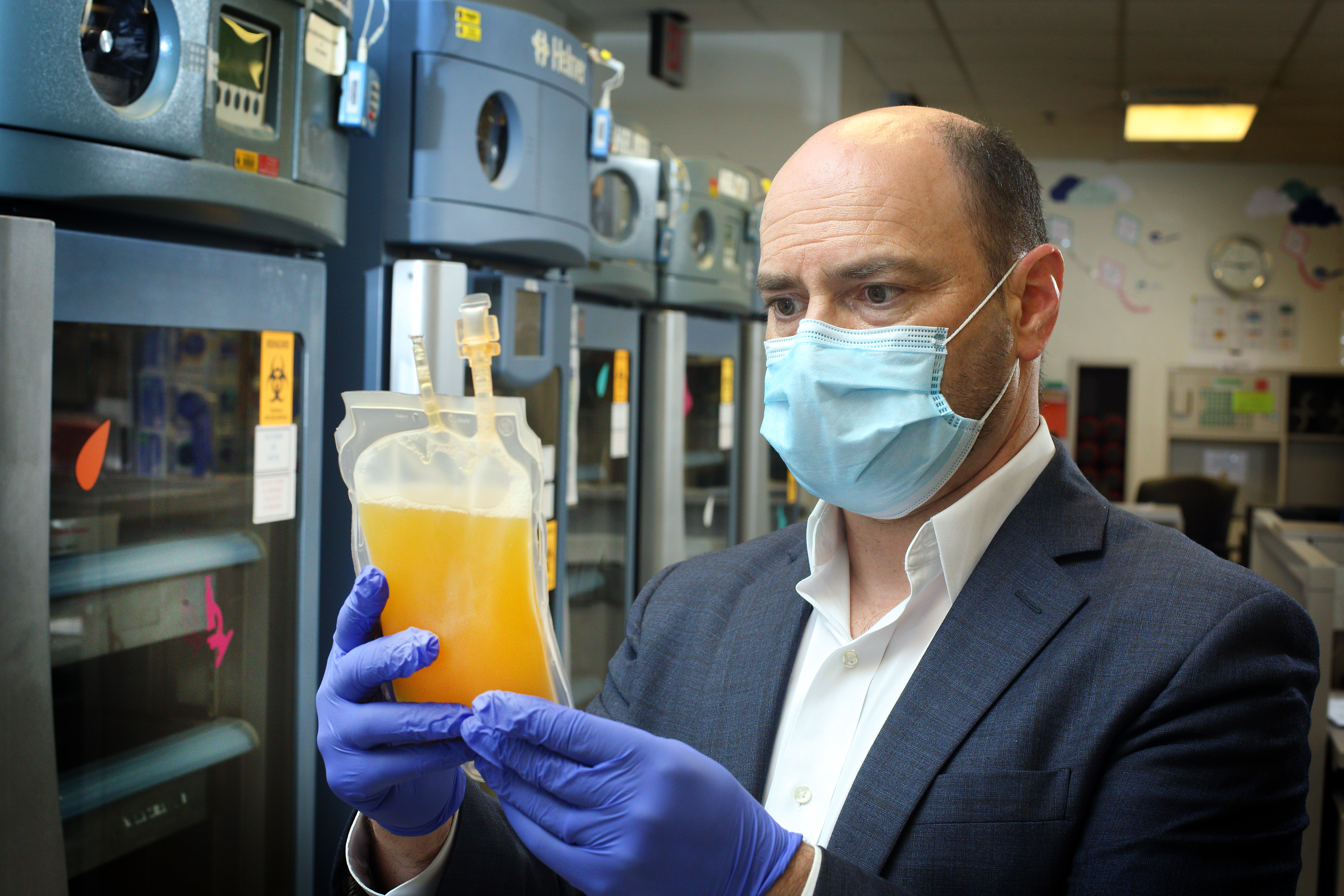 Shmuel Shoham holds bag of plasma