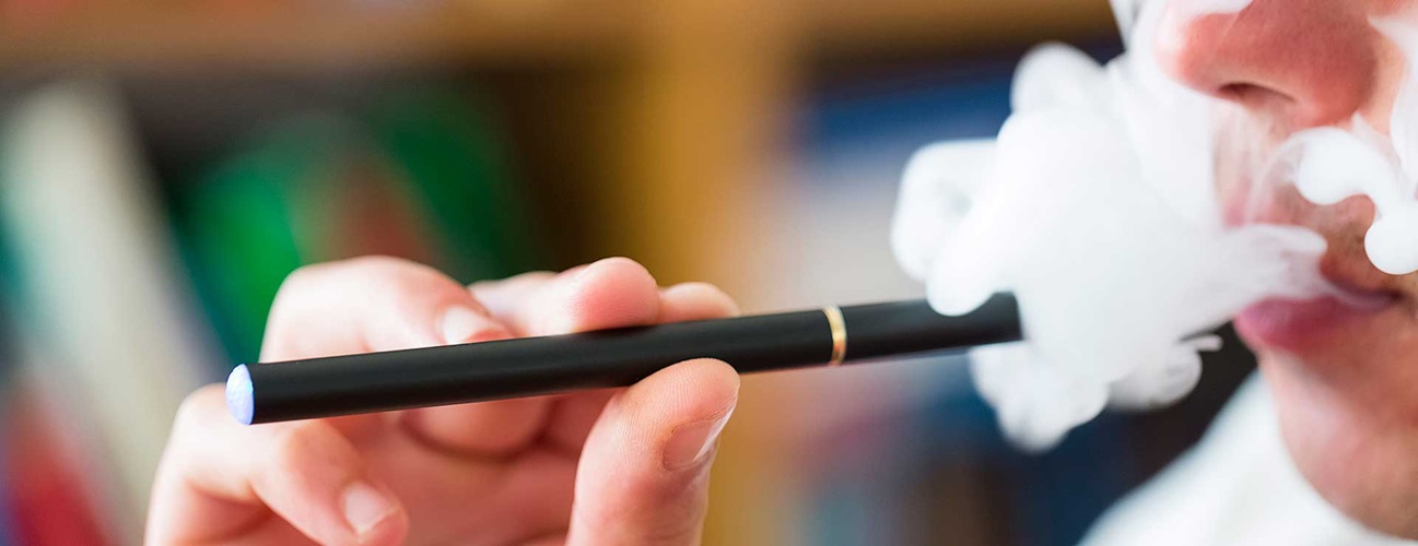 a man using a vaping e-cigarette