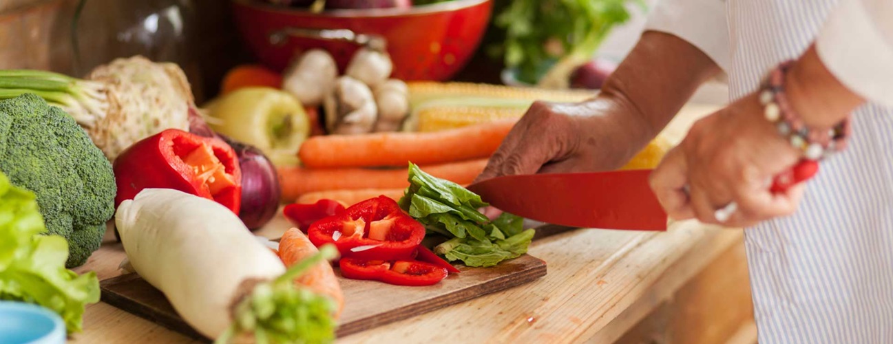 a chef cutting a variety of vegetables