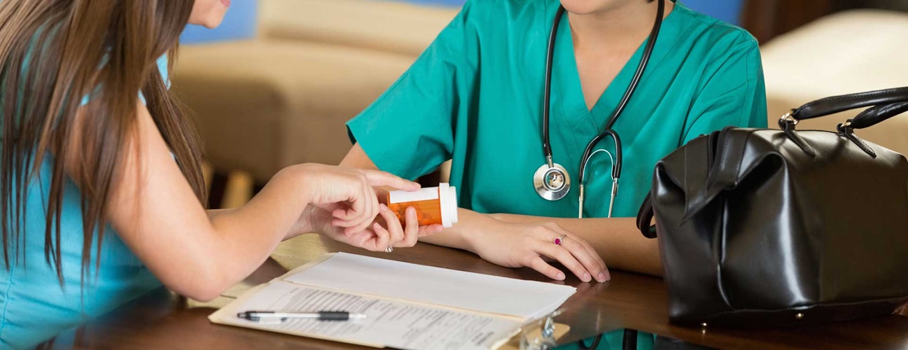 A woman checking medication with a nurse