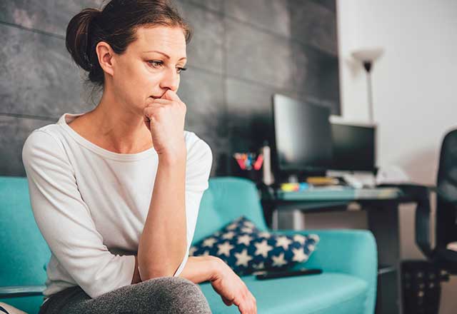 A woman worried and contemplating.