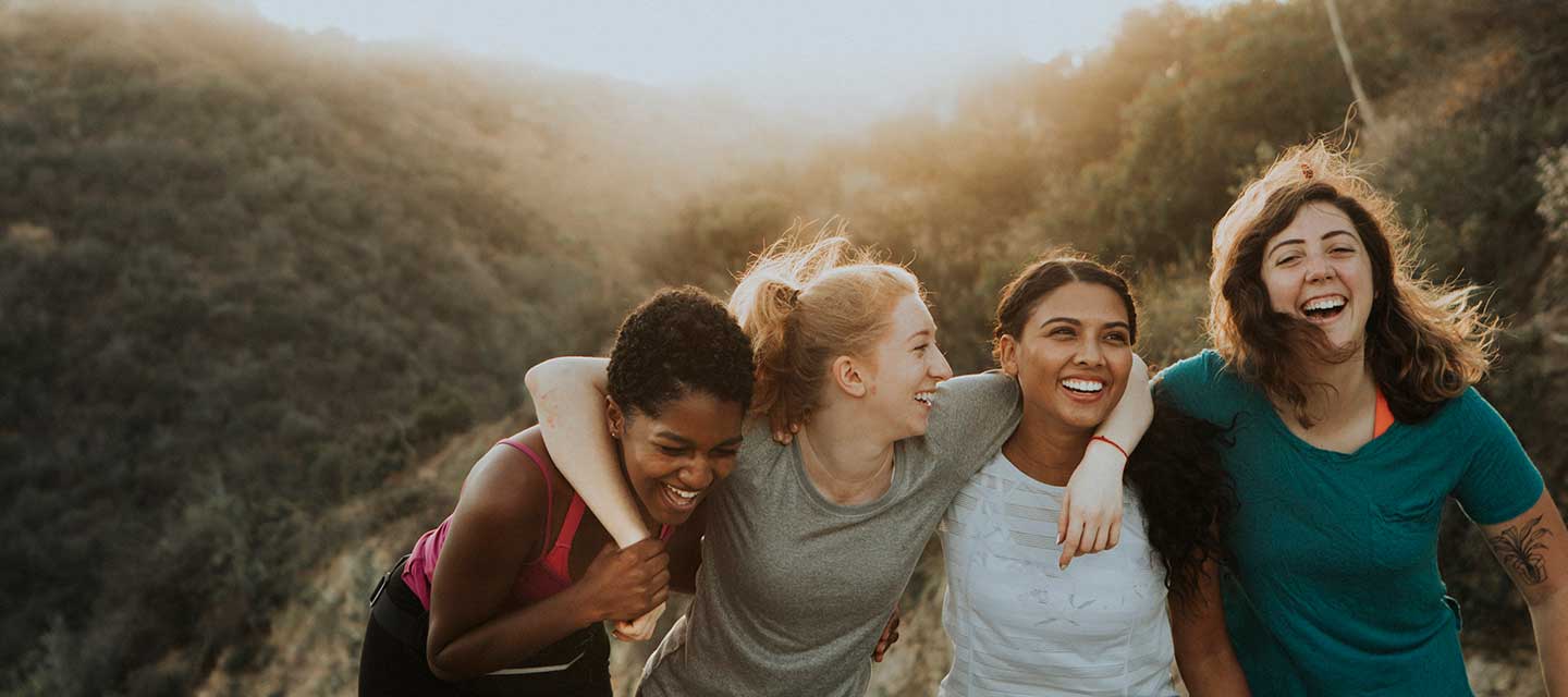 Group of diverse, young women on a rooftop