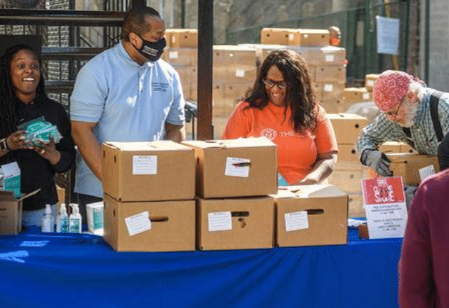 Members of the Mix Church and Johns Hopkins Government and Community Affairs staff assemble boxes of COVID-19 supplies.