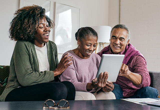 family looking at a tablet computer