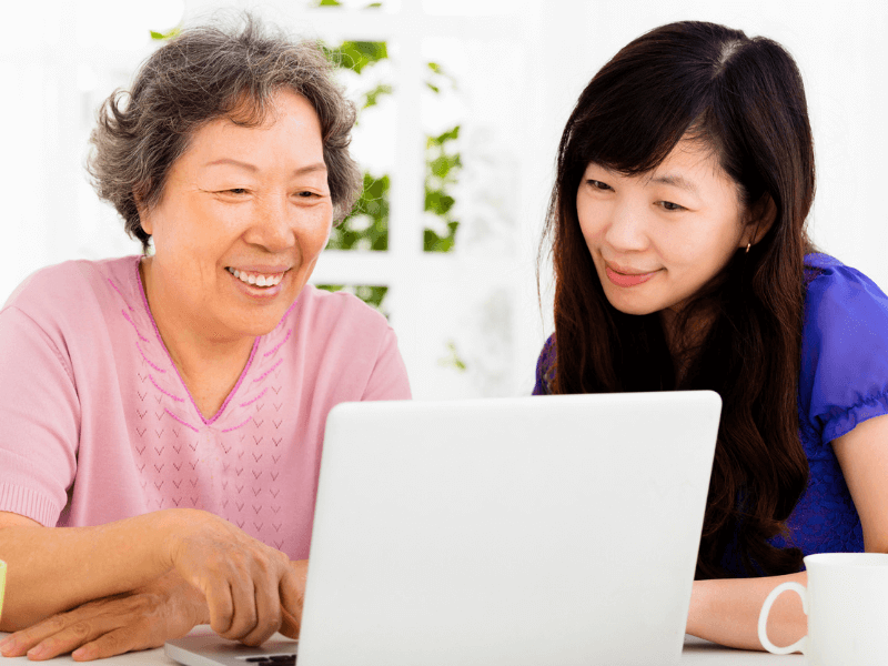 mother and daughter looking at the computer