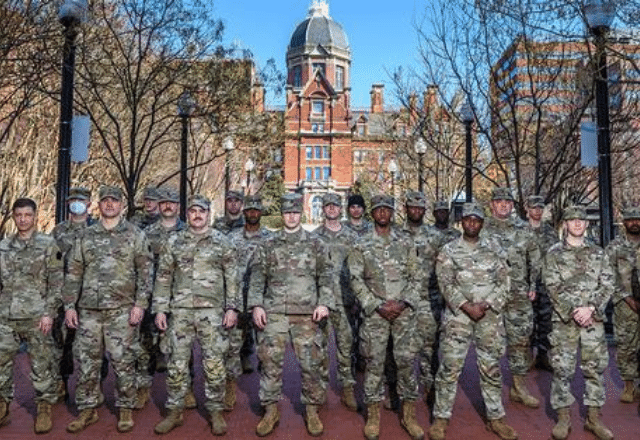 group of national guardspeople in front of the hopkins dome