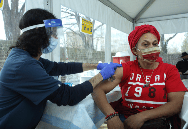 woman receiving vaccine at clinic