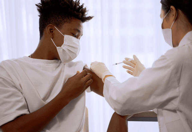 teen boy receiving vaccine