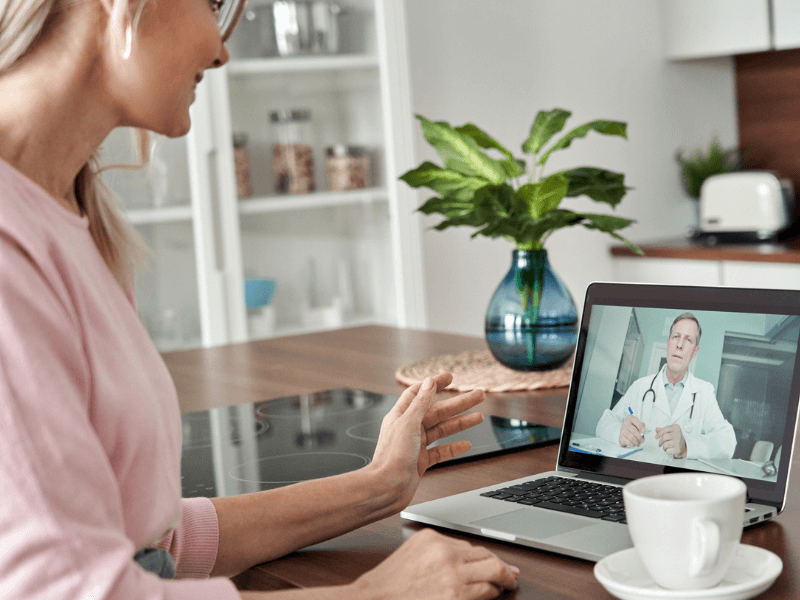 woman looking a doctor on laptop